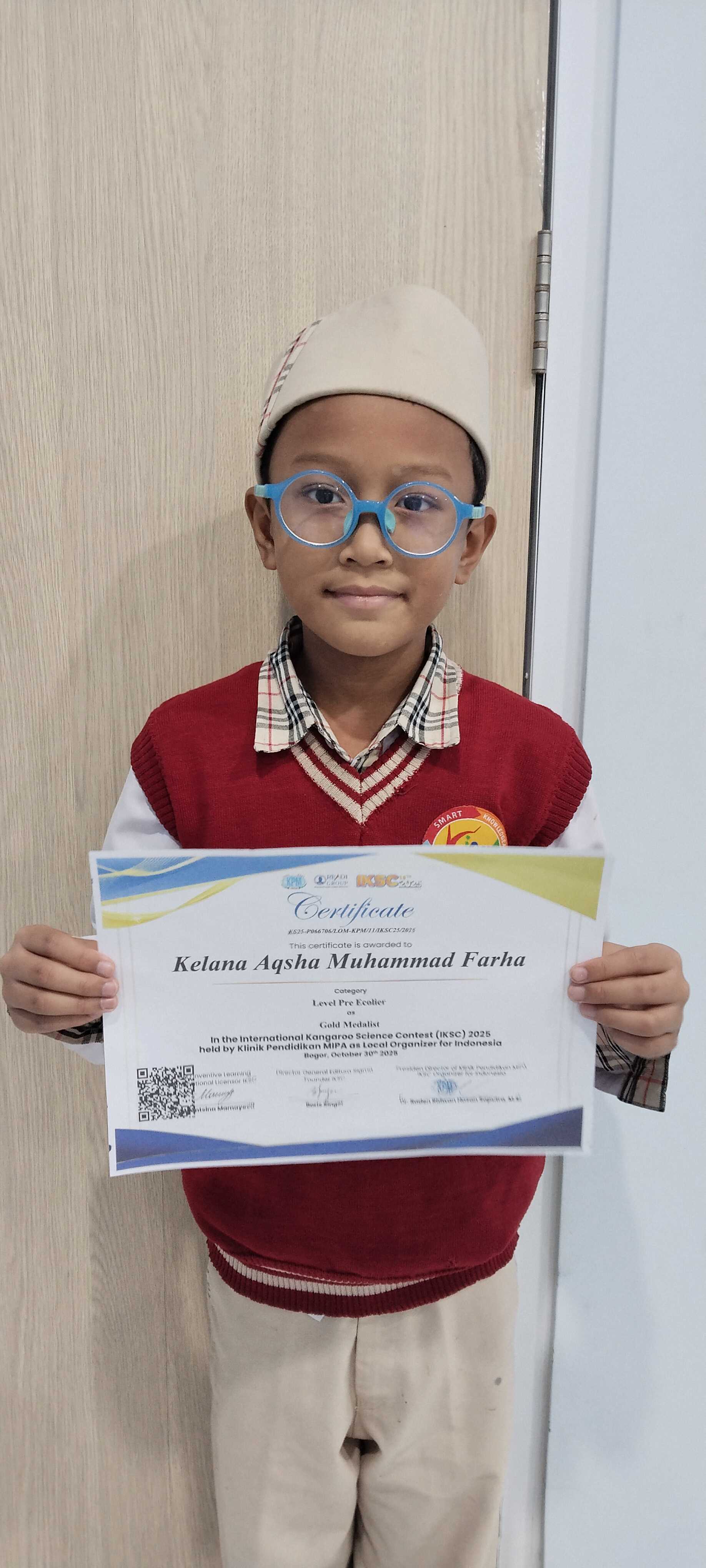 Kelana Aqsha Muhammad Farha holding his gold medal certificate