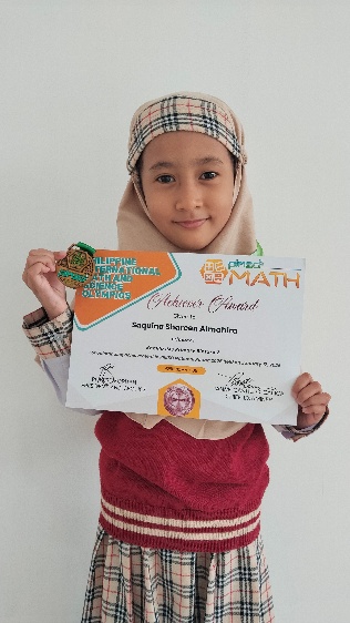 Saquina Shareen Almahira holding her PIMSO Math Olympiad merit certificate