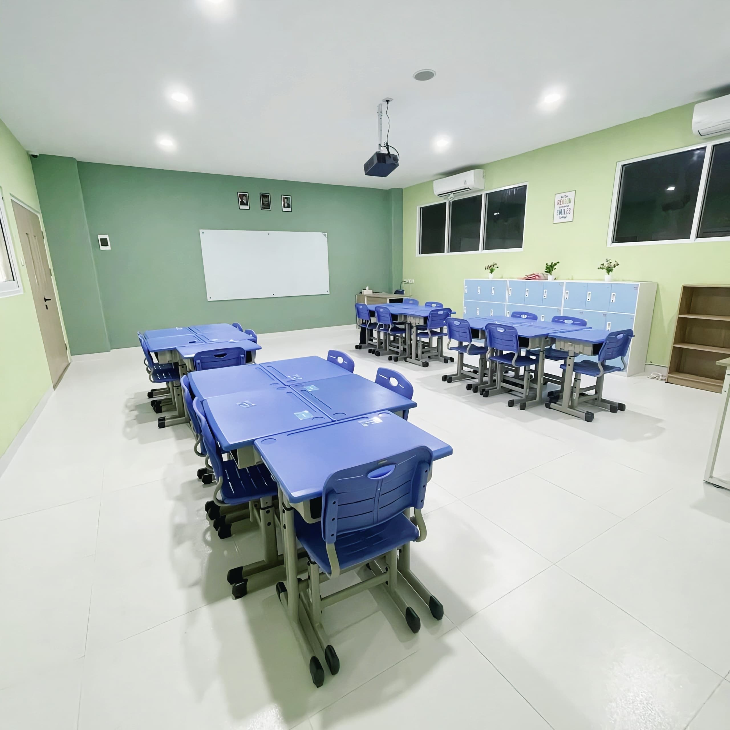 Green-themed classroom with desks, whiteboard, and lockers