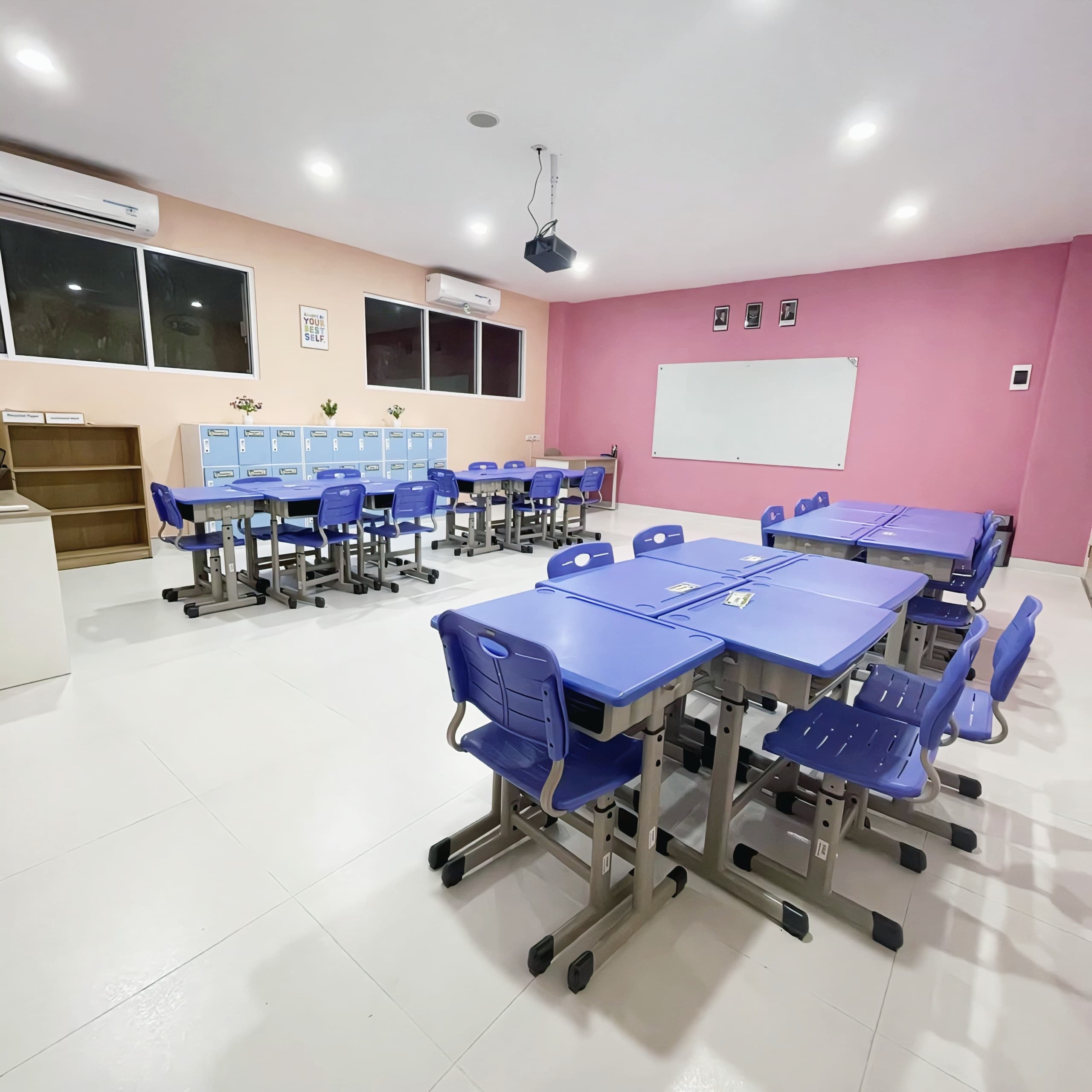 Pink-themed classroom with desks, whiteboard, and lockers